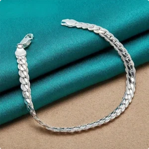 Premium 925 sterling silver flat side chain bracelet with a secure lobster clasp displayed on a luxury teal silk fabric